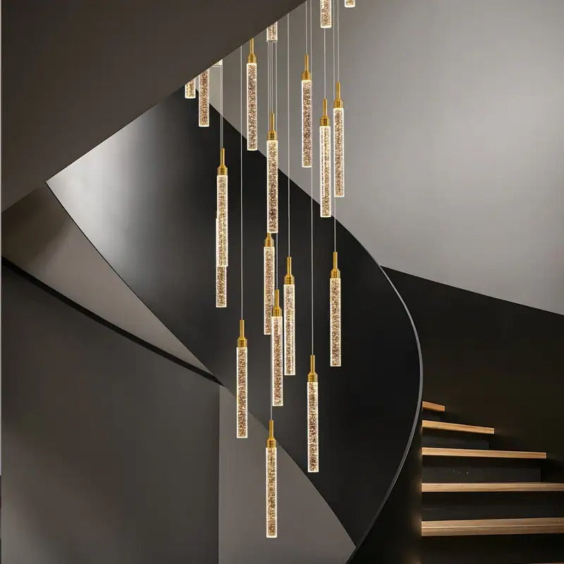 Uly Gold Crystal Chandelier for Staircase and High Ceiling with cascading crystal rods along a curved stairway