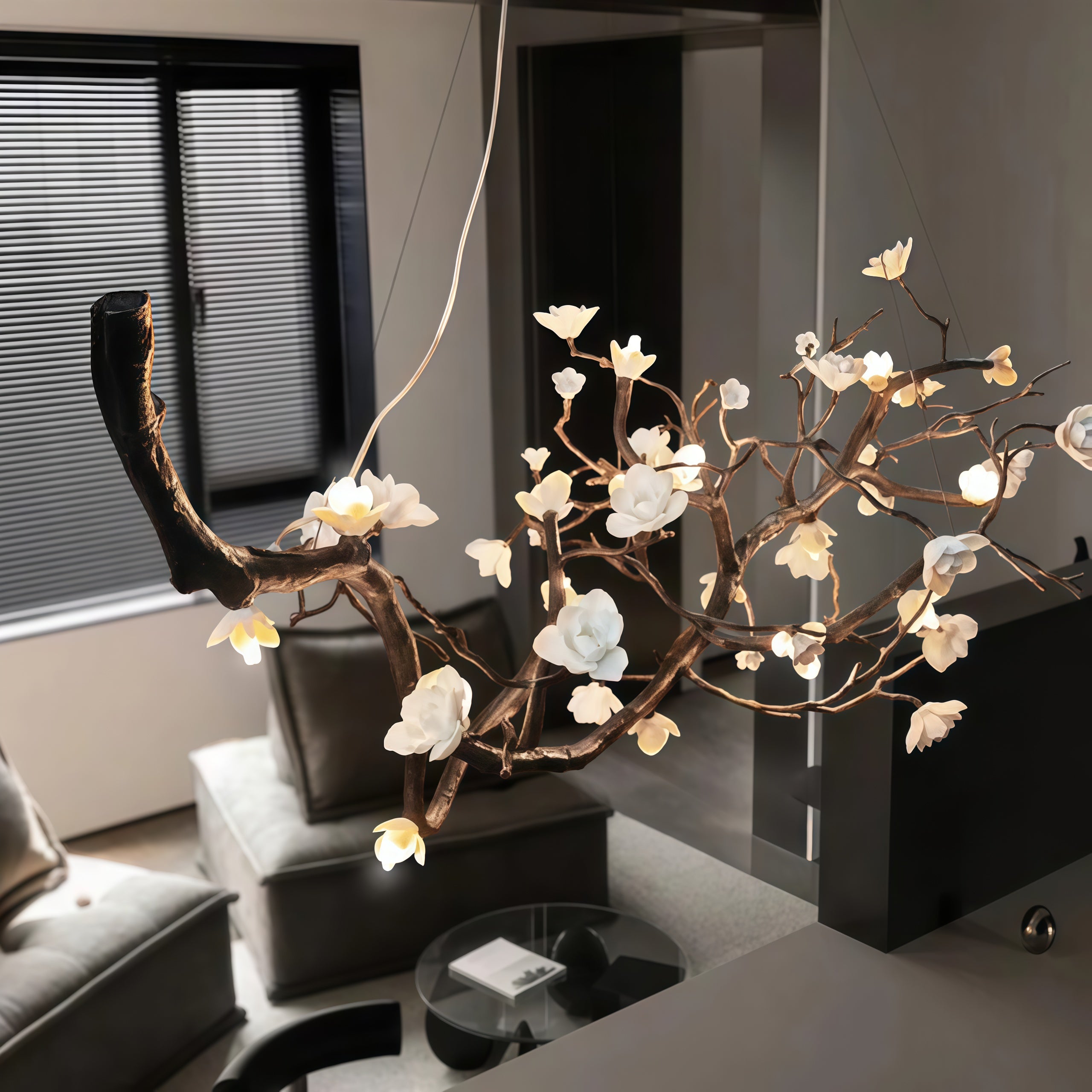 Close-up view of Wanos Ceramic Flower Branch Chandelier showing the handcrafted branch structure, white ceramic flowers, warm LED glow, and delicate suspension wires.