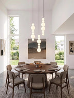 White Multi Globe Pendant Light for Staircase and High Ceiling in a bright dining area with vertical globe strands