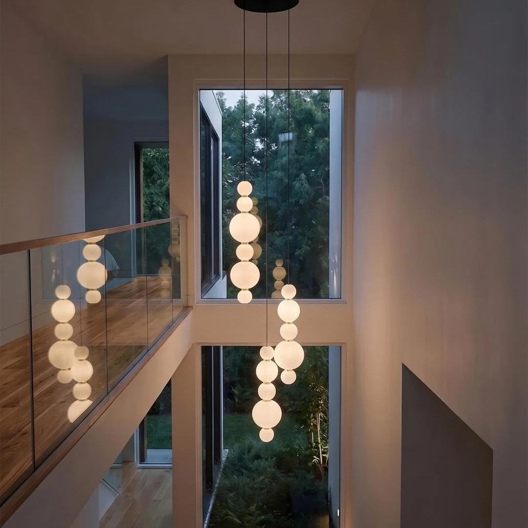 White Multi Globe Pendant Light for Staircase and High Ceiling in a tall entryway with opal glass globe strands