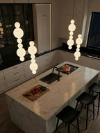 White Multi Globe Pendant Light for Staircase and High Ceiling in a minimalist kitchen island setting